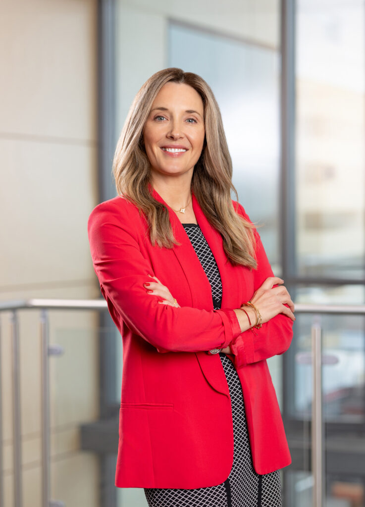 headshot of Stephanie wearing a red blazer