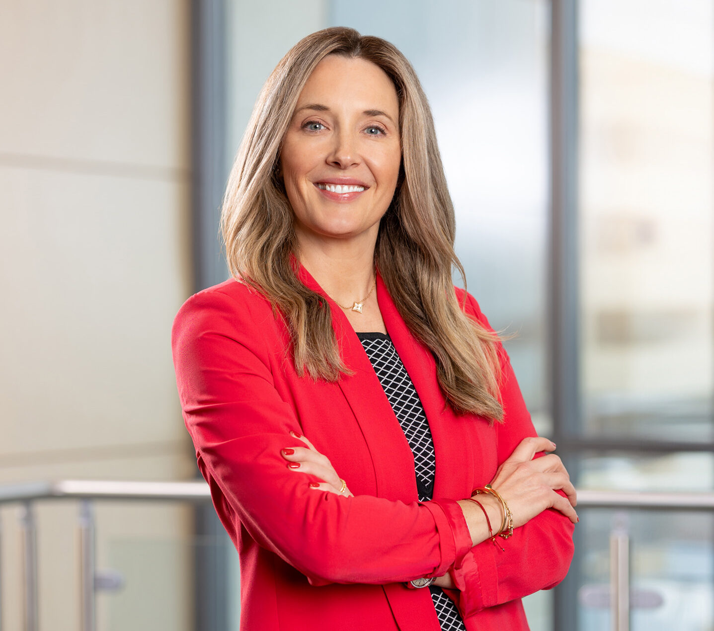 headshot of Stephanie wearing a red blazer