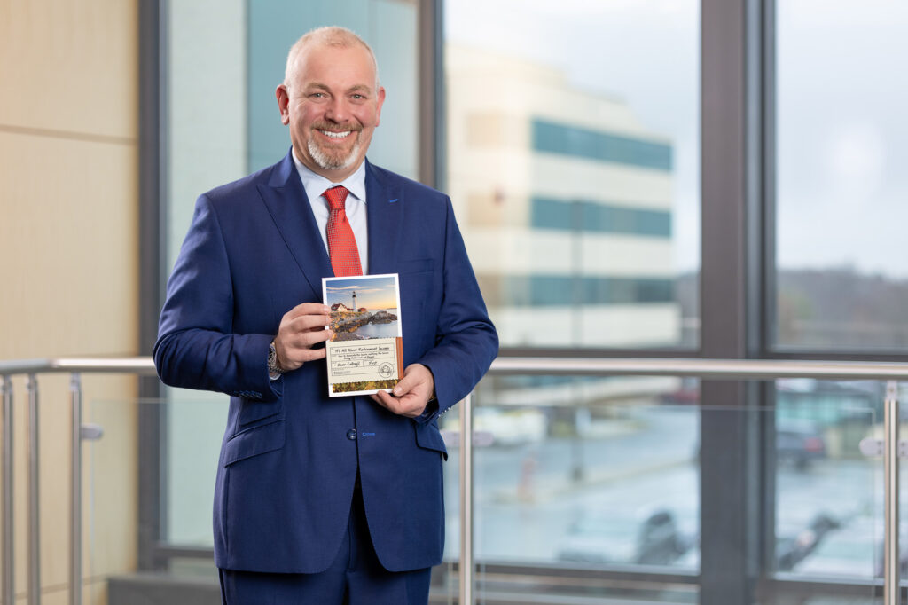 Elite Income Advisors employee smiling and holding a brochure