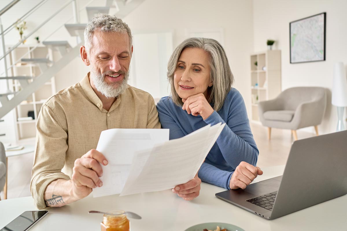 Older couple looking at paperwork for financial planning