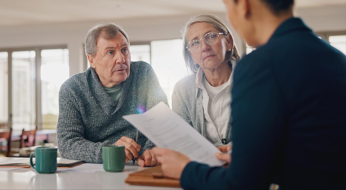 Senior couple meeting with a financial advisor to discuss their options for retirement planning.