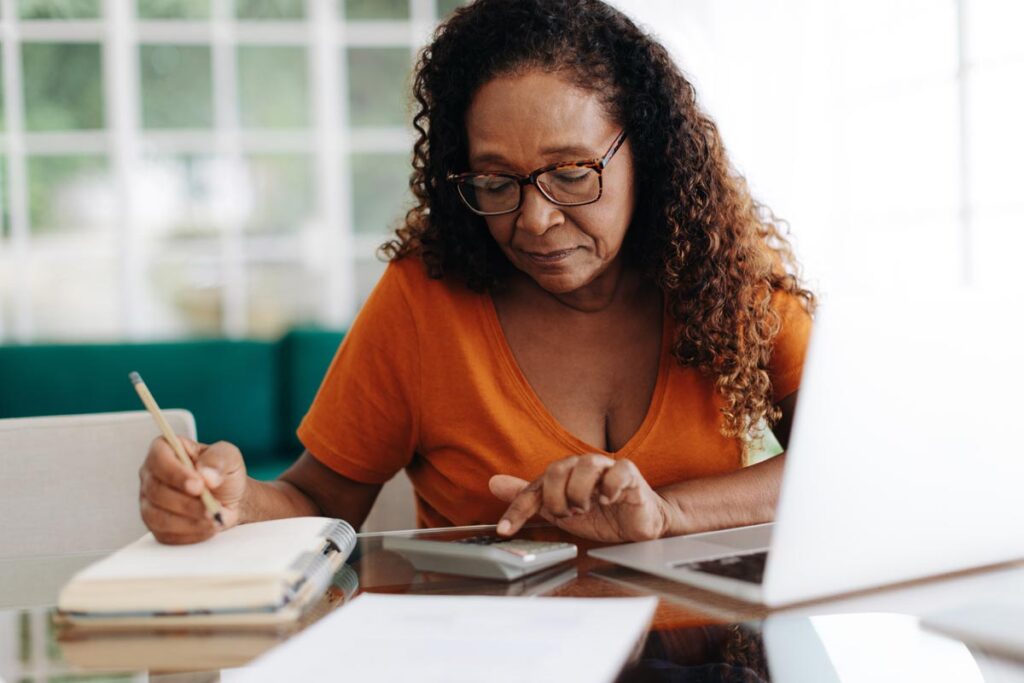 Senior woman calculating her retirement expenses.
