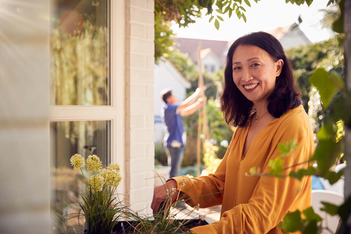 Mature woman enjoying early retirement gardening at home
