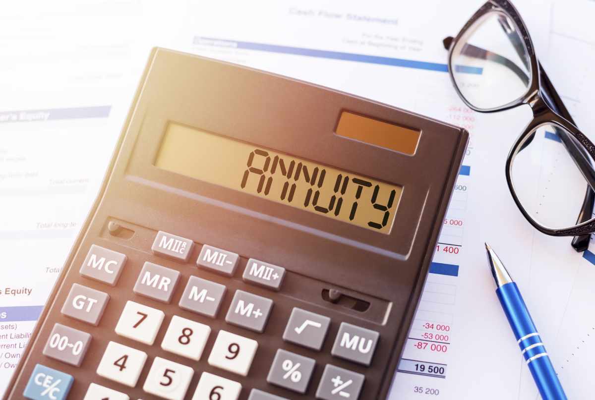Concept art depicting annuity planning with a calculator that displays the word ANNUITY on its LCD screen.