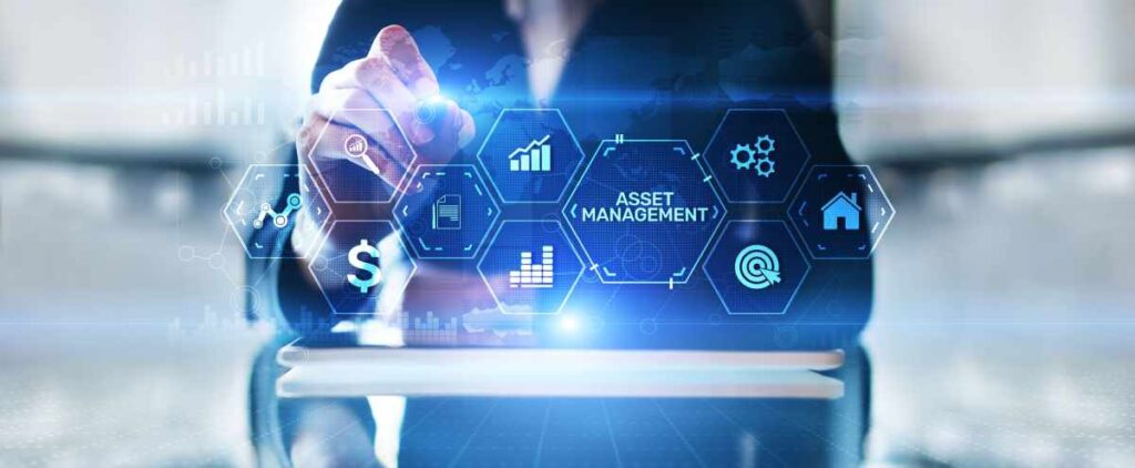 Concept photo of asset management: A series of digital-looking icons (one containing the words “ASSET MANAGEMENT,” others containing images of graphs and gears) are in the foreground as a person in the background examines them.