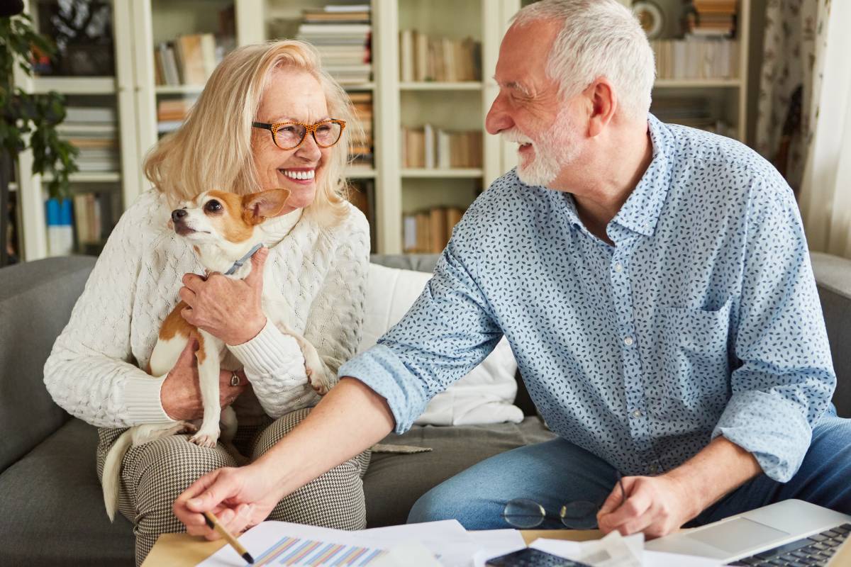 A senior couple looking at paperwork with a financial advisor.