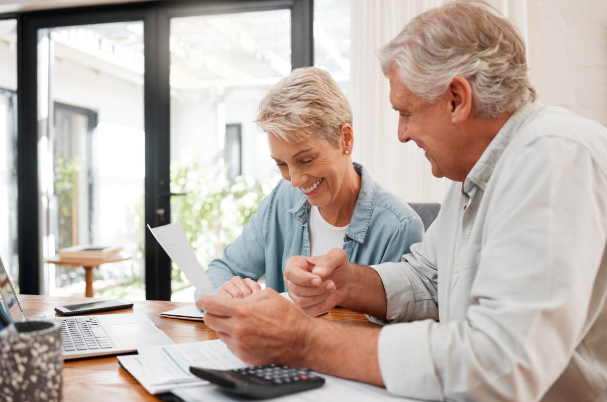 Senior couple reviewing retirement planning paperwork