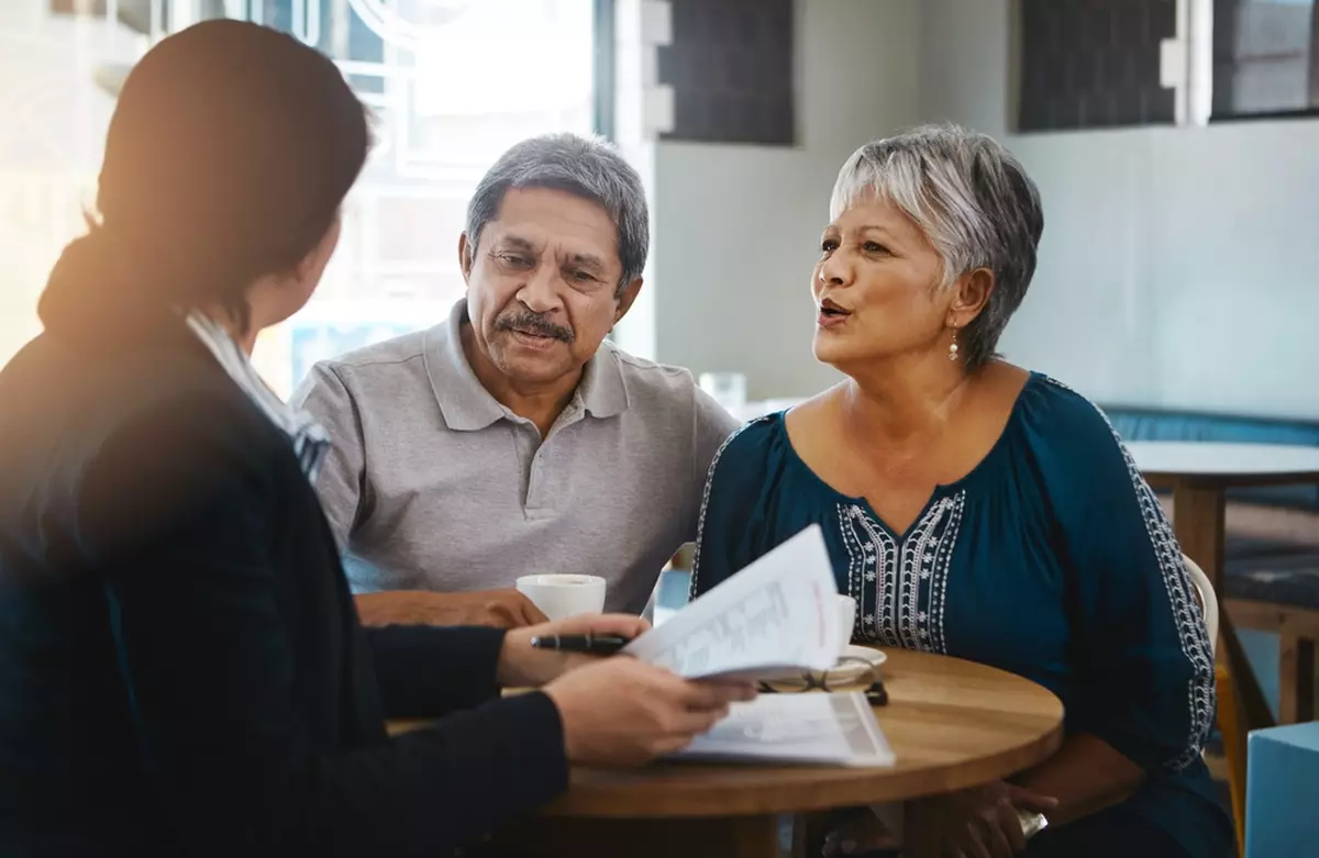 An older couple works with an advisor to plan for retirement.
