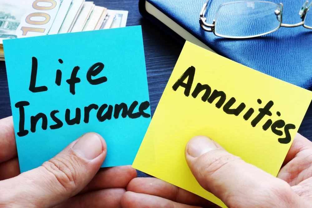 Annuity vs. pension comparison represented by life insurance and annuities written on sticky notes held in hands