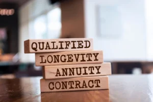 Qualified vs. non-qualified annuity concept with stacked wooden blocks labeled qualified, longevity, annuity, and contract