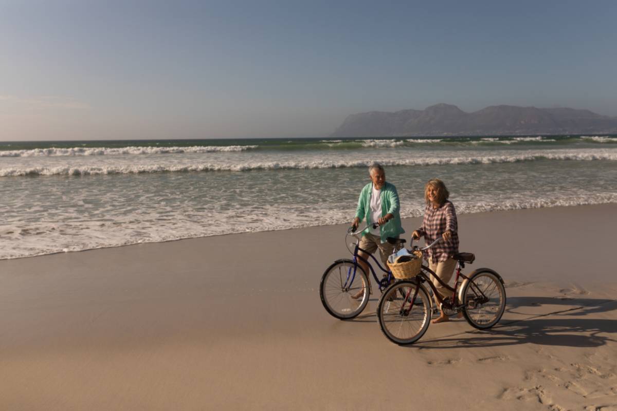 Active seniors biking on the beach in Ocean City, MD during retirement