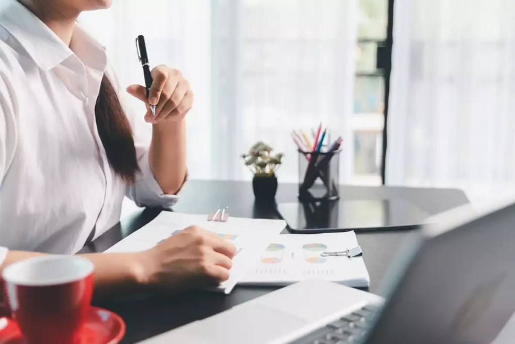 Retirement tax planning professional looks at printouts of retirees’ accounts to develop a tax planning strategy