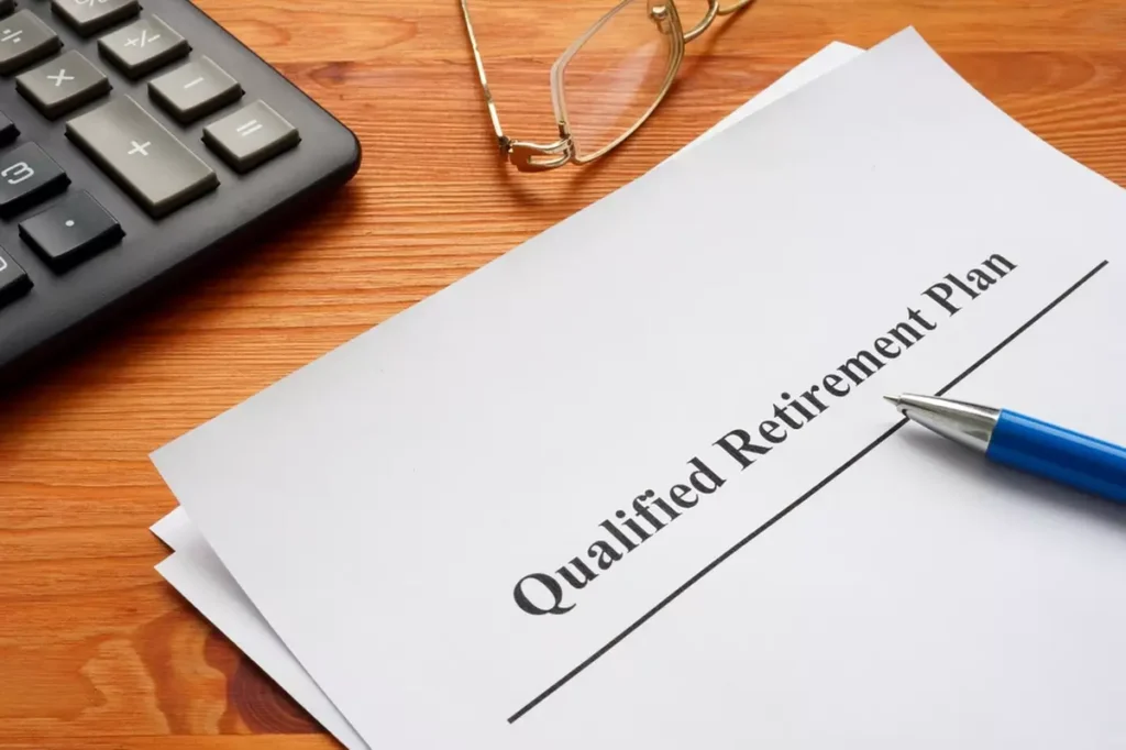 Qualified retirement plan, a calculator and glasses.