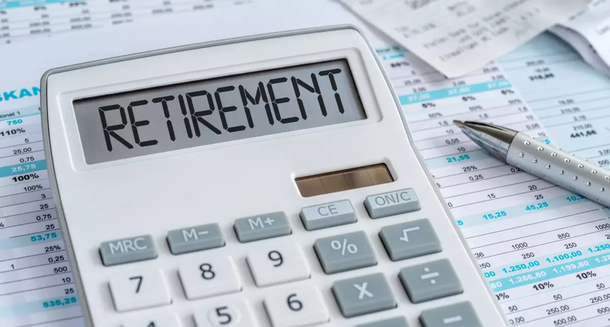 A calculator on paperwork, spelling out ‘retirement’ across its face.