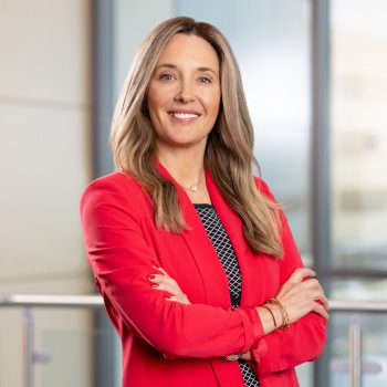 headshot of Stephanie wearing a red blazer
