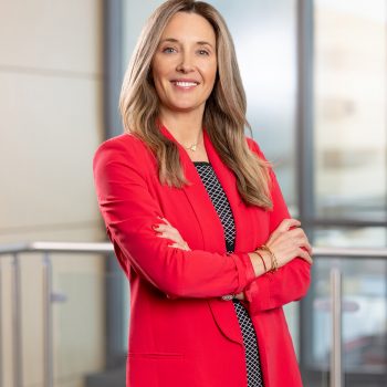 headshot of Stephanie wearing a red blazer